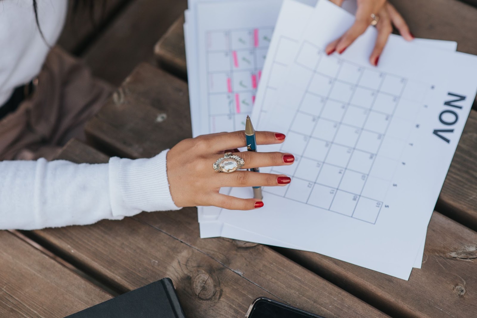 Women sifting through the employee onboarding program schedule