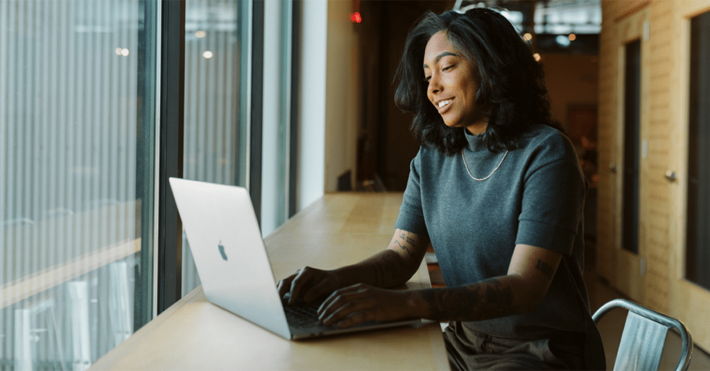 Mulher trabalhando no laptop em um escritório.