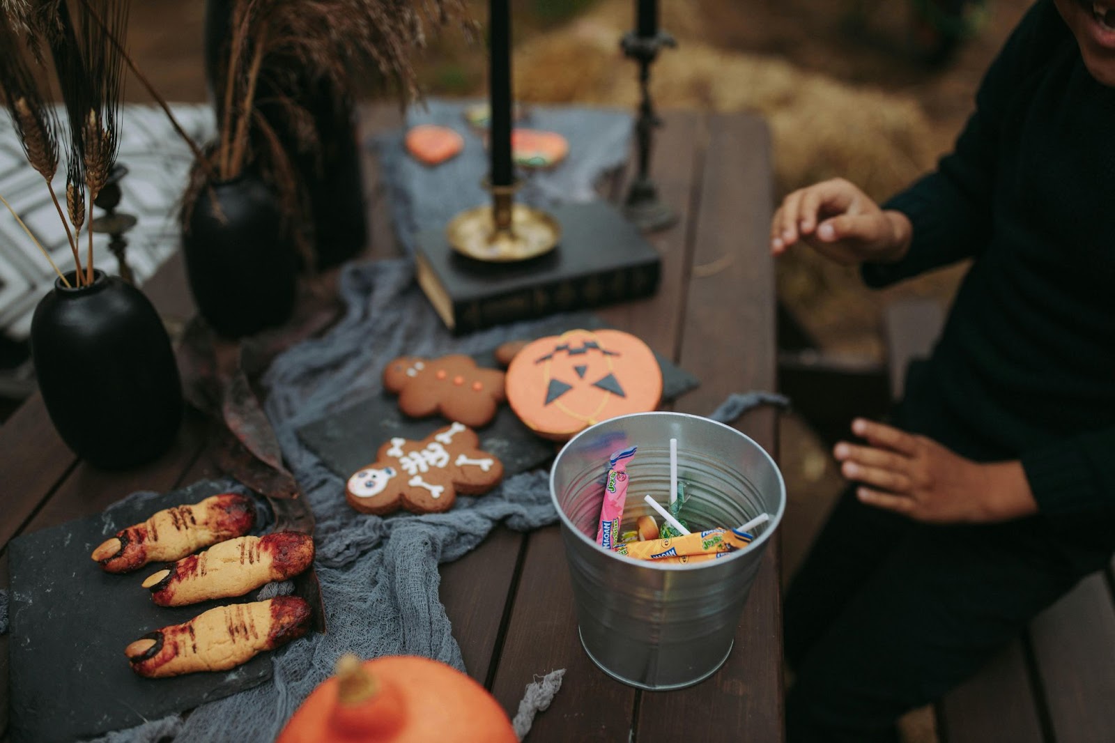 Kue bertema Halloween didekorasi di ruang luar yang pedesaan, seperti gudang.